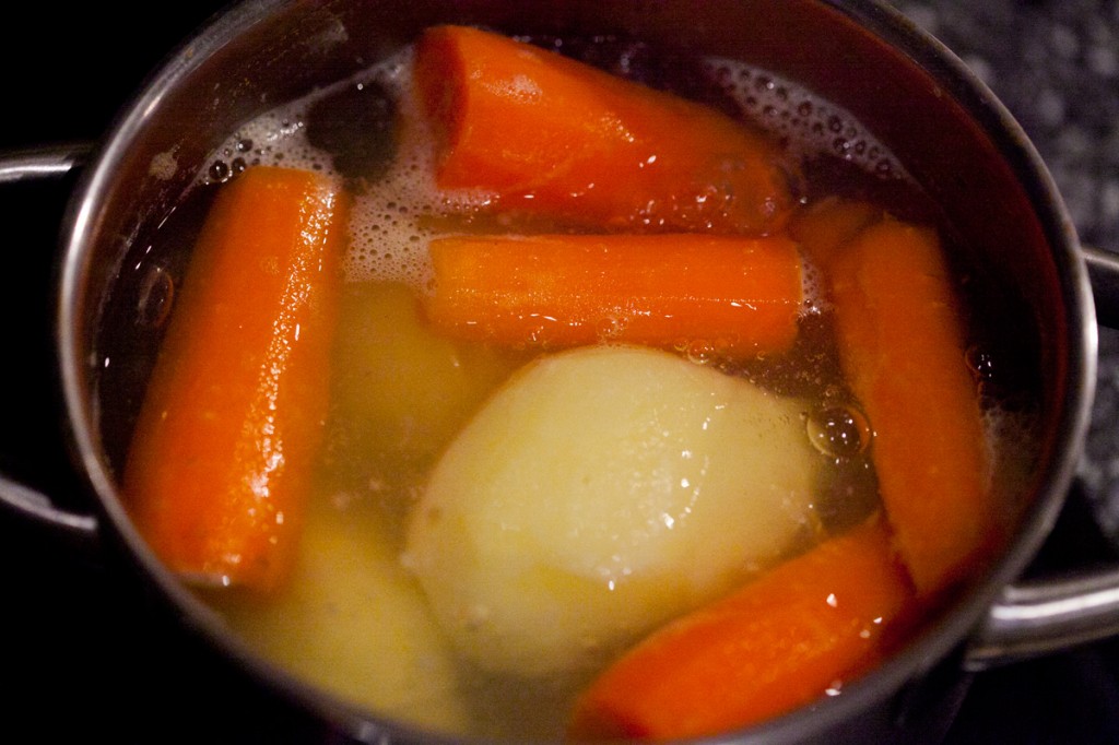 Boiling the carrots and potatoes