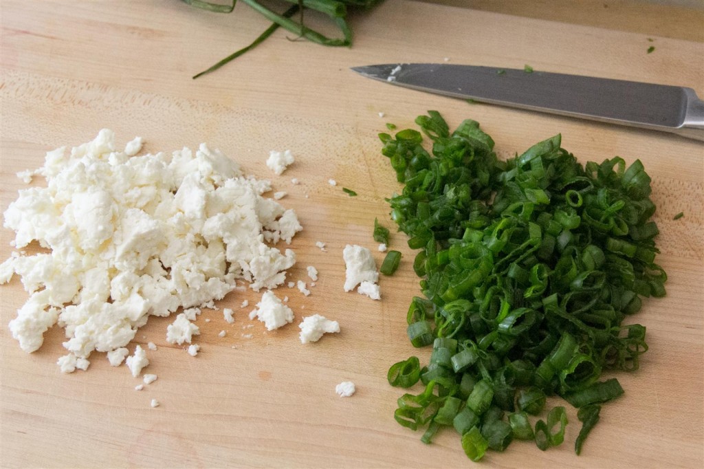 Crumbling the feta and onions