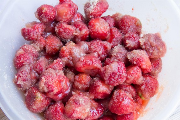 Mixing the strawberries with sugar