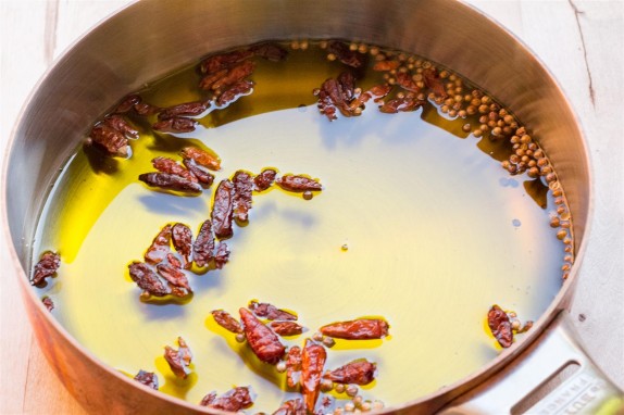 Warming the chilies in the oil