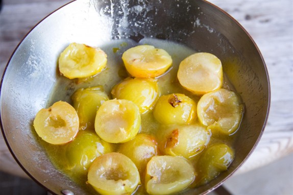 Lightly stewing the plums in their juice with sugar
